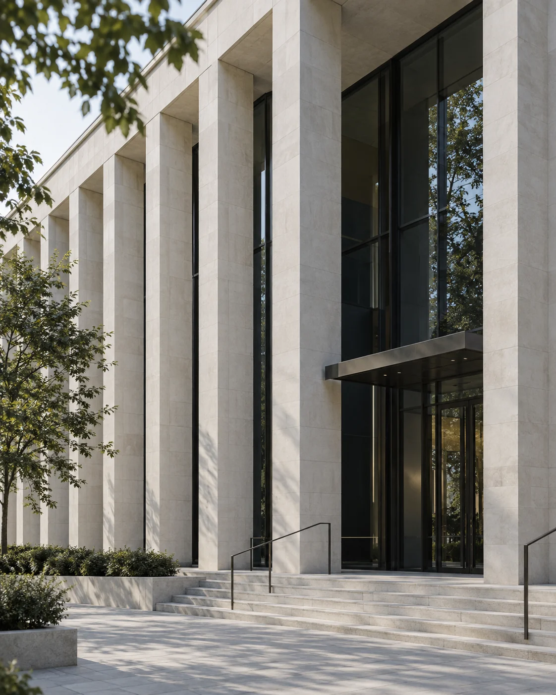 Pale stone columns and a glass entrance; illustrative architectural image